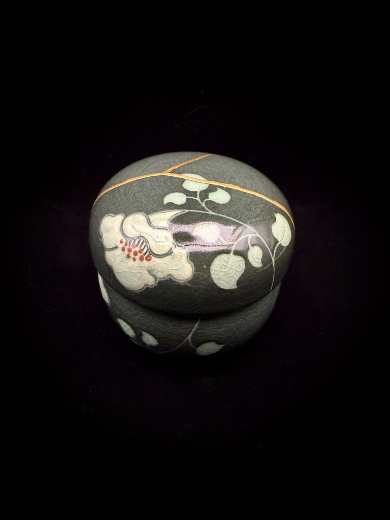 a green tea cup repaired using the kintsugi technique